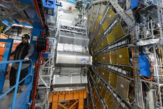 A technician works in the LHC (Large Hadron Collider) tunnel of the European Organization for Nuclear Research, CERN, during a press visit in Meyrin, near Geneva, Switzerland, Feb. 16, 2016. (Laurent Gillieron/Keystone via AP, File) 