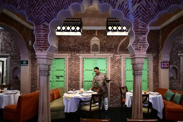  This photograph taken on February 2, 2026 shows a hospitality staff arranging tableware at the Dharampura Haveli, an 18th-century haveli-turned-heritage hotel in the old quarters of Delhi. (AFP)