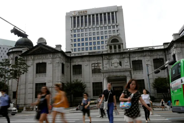 FILE PHOTO: People walk on a zebra crossing in front of the buliding of Bank of Korea in Seoul, South Korea, July 14, 2016.  REUTERS/Kim Hong-Ji/File Photo