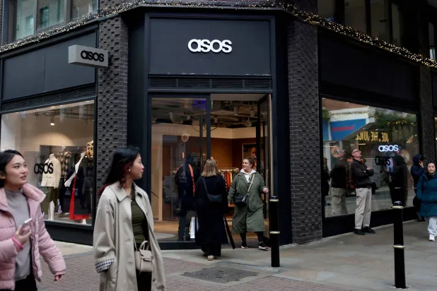 FILE PHOTO: People walk past the ASOS pop-up store in London, Britain, November 12, 2025. REUTERS/Hannah McKay/File Photo/File Photo