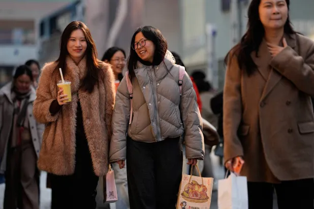 Women tour a popular outdoor shopping mall in Beijing, China, Sunday, March 8, 2026. (AP Photo/Andy Wong)