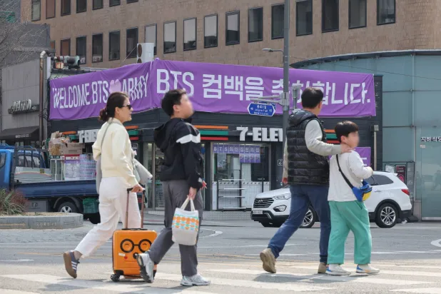 People walk near Gwanghwamun Square in Seoul, South Korea, 22 March 2026. The band performed their comeback concert on 21 March.  EPA/YONHAP