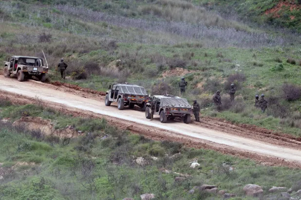 Israeli military vehicles maneuver on the Lebanese side of the border, as seen from the Upper Galilee in northern Israel, 25 March 2026. EPA/ATEF SAFADI