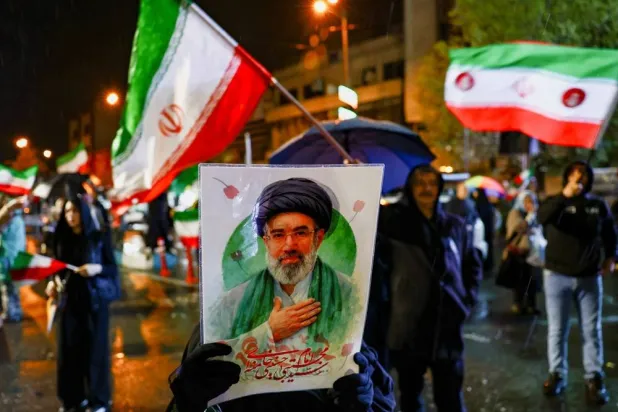A woman holds a poster depicting Iran’s new Supreme Leader Mojtaba Khamenei during an anti-US and anti-Israeli rally, amid the US-Israeli conflict with Iran, in Tehran, Iran, March 26, 2026. Majid Asgaripour/WANA (West Asia News Agency) via Reuters