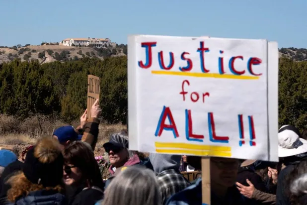 Zorro Ranch, a property formerly owned by Jeffrey Epstein, stands behind a protest sign that reads "Justice for all" on International Women’s Day near Stanley, New Mexico, US, March 8, 2026. (Reuters) 