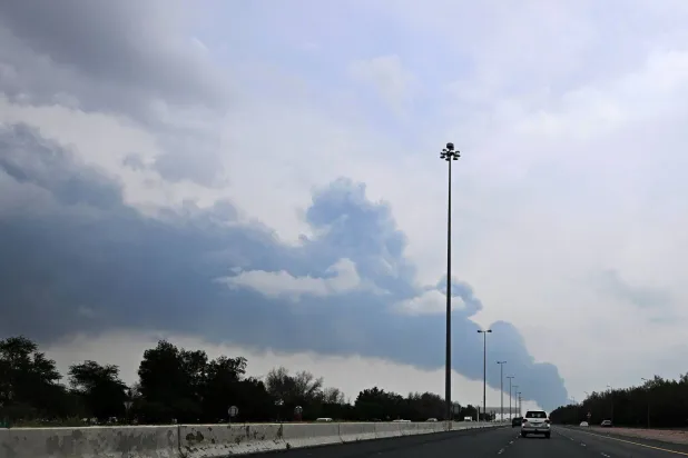 Smoke rises from the area of the Kuwait International Airport after a reported drone strike hit a fuel depot on March 25, 2026. AFP