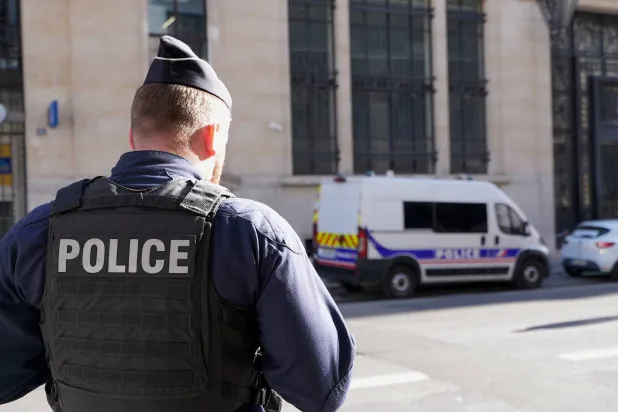 Police stand outside the Bank of America building in Paris, Saturday, March 28, 2026. (AP)