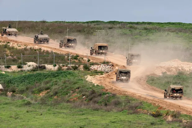 Israeli military vehicles maneuver on the Lebanese side of the border, as seen from the Upper Galilee in northern Israel, 25 March 2026. EPA/ATEF SAFADI