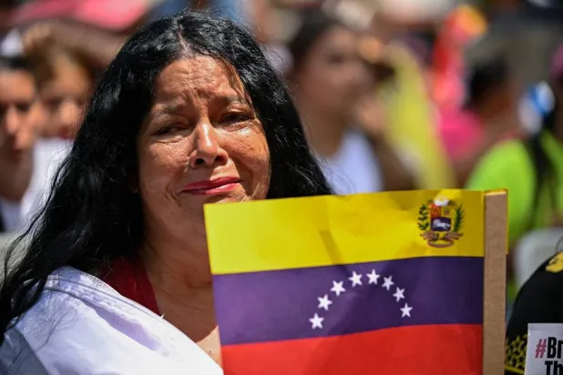 A supporter of ousted Venezuelan President Nicolas Maduro and his wife Cilia Flores reacts while gathering with others in support of Maduro and Flores on the day they attend a hearing in a Manhattan federal court, more than two months after US military forces captured them in a surprise raid on Caracas and ferried them to New York, in Caracas, Venezuela, March 26, 2026. (Reuters) 