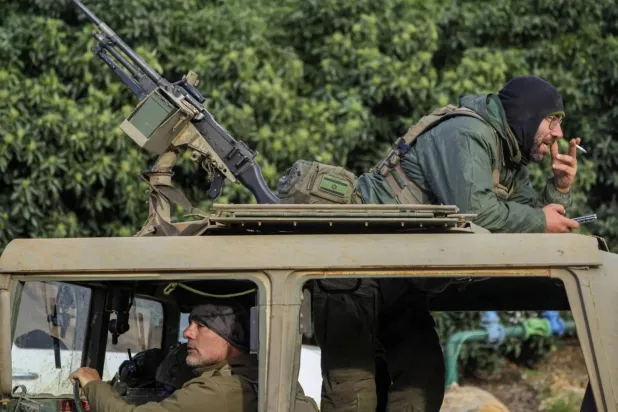Israeli soldiers aboard a military vehicle at the Lebanese border (Reuters). 