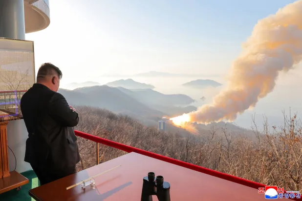 This undated picture released by North Korea's official Korean Central News Agency (KCNA) on March 29, 2026 shows North Korean leader Kim Jong Un inspecting a combustion test of a solid-fuel rocket engine at an undisclosed location in North Korea. (KCNA via KNS / AFP) 
