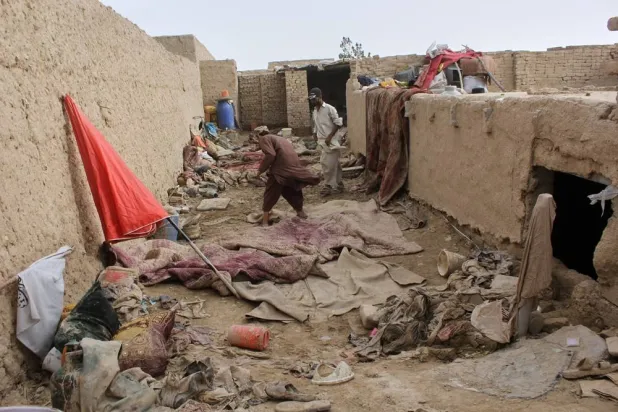 Locals inspect a damaged house following floods, landslides and thunderstorms in Kandahar province, Afghanistan, Sunday, March 29, 2026. (AP) 