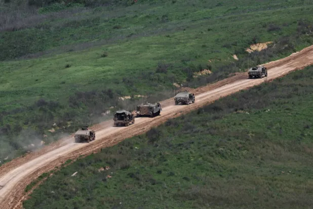 Israeli military vehicles on the Lebanese side of the border (EPA)