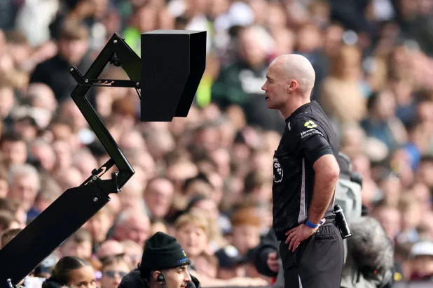 Football - Premier League - Aston Villa v West Ham United - Villa Park, Birmingham, Britain - March 22, 2026 Referee Paul Tierney checks the VAR before overturning an Aston Villa penalty. (Action Images via Reuters) 