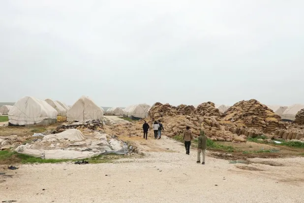People inspect the site of a destroyed wheat warehouse following the downing of drones near the US base in Qasrak, as the US-Israeli conflict with Iran continues, in the Hasakeh countryside, Syria, March 29, 2026. (Reuters)