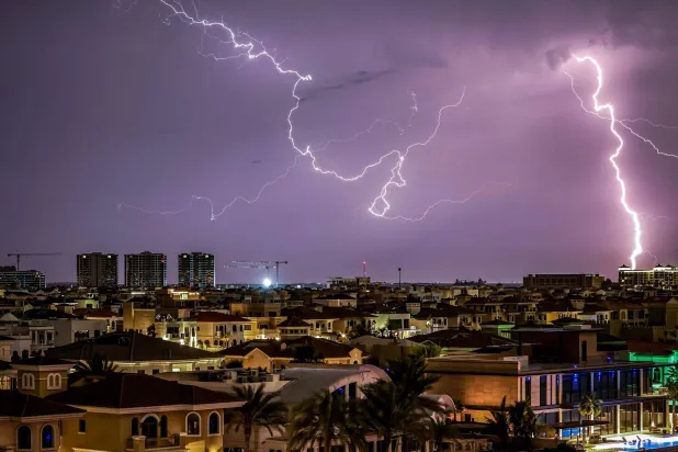 Lightning illuminates the sky over Dubai during a thunderstorm on March 26, 2026. (Photo by FADEL SENNA / AFP)