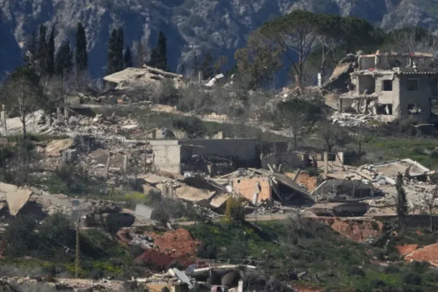 An Israeli tank maneuvers in southern Lebanon near the border with Israel, Sunday, March 8, 2026. (AP Photo/Ariel Schalit)