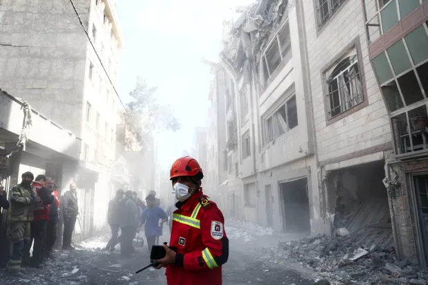 Emergency responders inspect the site of a residential building damaged by a strike, amid the US-Israeli conflict with Iran, in Tehran, Iran, March 27, 2026. Majid Asgaripour/WANA (West Asia News Agency) via Reuters 