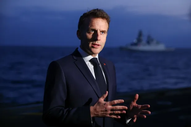  French President Emmanuel Macron speaks to members of the media as he visits the French aircraft carrier Charles de Gaulle, during his visit to Cyprus, Monday March 9, 2026. (Gonzalo Fuentes/Pool Photo via AP) 