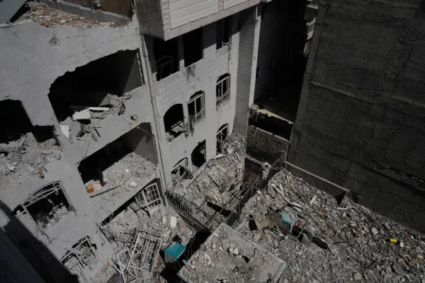 A building is damaged after a nearby residential building was hit in an overnight US-Israeli strike in Tehran, Friday, March 27, 2026. (AP) 