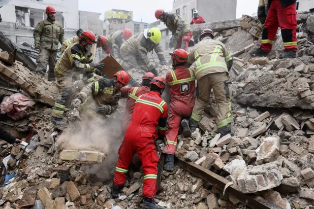 FILE - Rescue workers search for survivors in the rubble after a strike in southern Tehran, Iran, March 13, 2026. (AP Photo/Sajjad Safari, File)