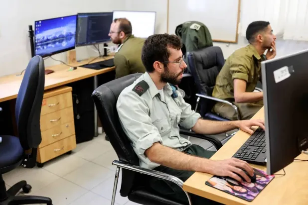 Technologists with the Israeli military’s Matzpen operational data and applications unit work at their stations, at an Israeli Army base in Ramat Gan, Israel. (Reuters)