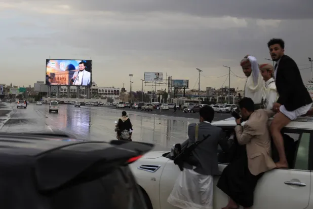 People ride in a vehicle past a digital billboard featuring Houthi leader Abdul-Malik al-Houthi in Sanaa, Yemen, 31 March 2026. EPA/YAHYA ARHAB