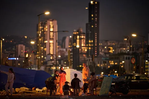  Members of a family who fled Israeli shelling in southern Lebanon warm themselves by a bonfire next to tents used as shelters in Beirut, Lebanon, Tuesday, March 31, 2026. (AP) 
