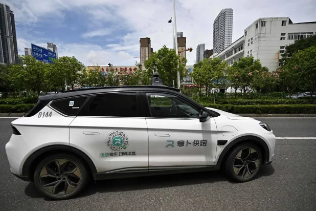 This file photo taken on August 1, 2024 shows a general view of a driverless robotaxi autonomous vehicle developed as part of tech giant Baidu's Apollo Go self-driving project, in Wuhan, in central China's Hubei province. (Photo by PEDRO PARDO / AFP)
