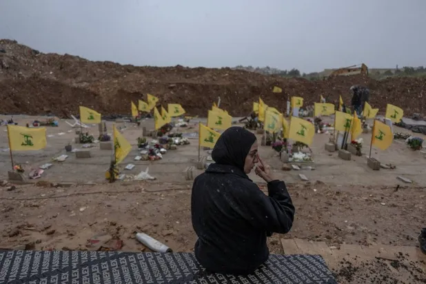 A woman sits in a cemetery before the funeral of Lebanese journalists, Al Manar reporter Ali Shoeib, Al Mayadeen reporter Fatima Ftouni and cameraman Mohammed Ftouni, who were killed by a targeted Israeli strike, amid escalating hostilities between Israel and Hezbollah, as the US-Israeli conflict with Iran continues, in Choueifat, Lebanon, March 29, 2026. (Reuters) 