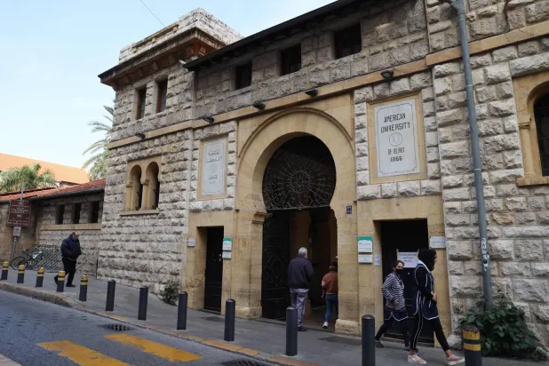 People walk past the main gate to the campus of the American University of Beirut (AUB) in the center of Beirut on January 13, 2022. (AFP)