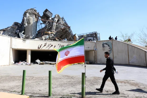 رجل يسير بجوار معلم إيران في طهران (إ.ب.أ)