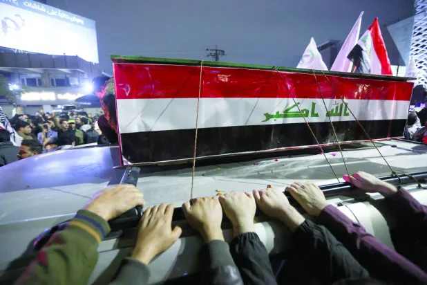 Mourners attend the funeral of members of Iraq's Hashed al-Shaabi, who were killed in an airstrike in the town of al‑Qaim near the Syrian border, amid heightened regional tensions due to the US-Israel conflict with Iran, in Baghdad, Iraq, March 12, 2026. REUTERS/Stringer