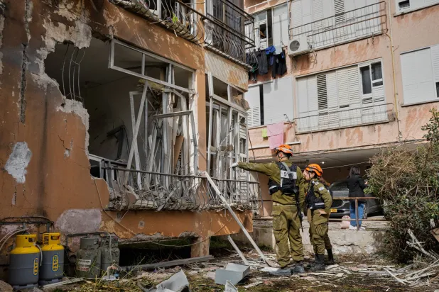 Israeli security forces inspect damage at an apartment building struck by an Iranian missile in Petah Tikva, Israel, Saturday, April 4, 2026. (AP)