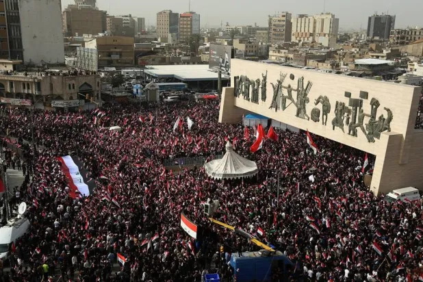 Followers of Iraq's Moqtada al-Sadr wave Iraqi national flags during a protest against the joint US-Israeli strikes on Iran, as they gather in Tahrir Square, Baghdad, Iraq, 04 April 2026. (EPA)