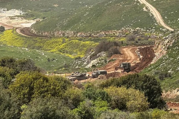 Israeli military vehicles drive through mud on the Lebanese side of the Israel-Lebanon border, after Israeli forces launched a campaign against Iran-backed Hezbollah in southern Lebanon, amid the US-Israeli conflict with Iran, as seen from northern Israel April 4, 2026. (Reuters) 