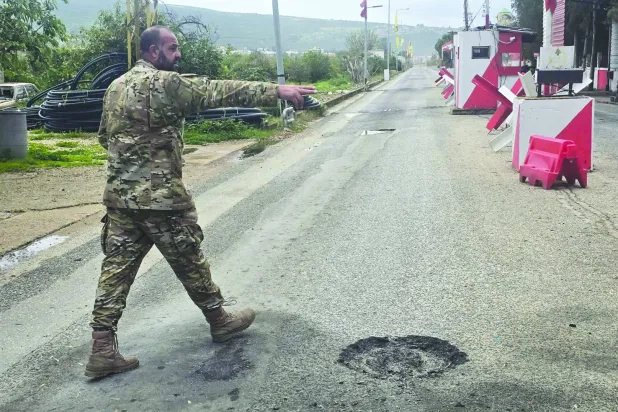 A Lebanese army soldier inspects the site of an Israeli airstrike that targeted their checkpoint in Aamriyeh, south of the coastal city of Tyre, on March 30, 2026. (Photo by KAWNAT HAJU / AFP)