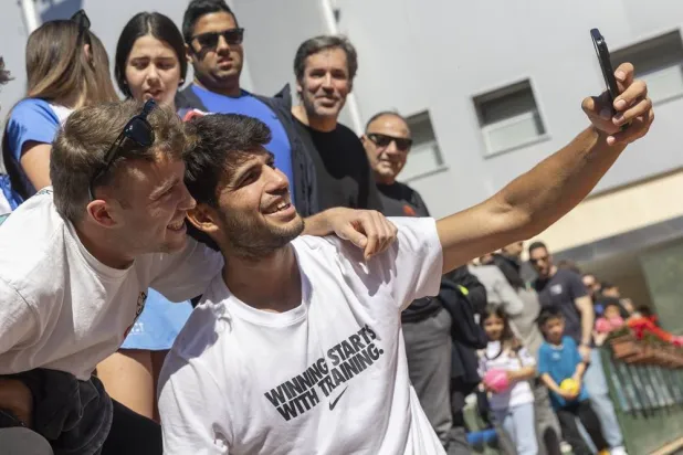 Spanish tennis player Carlos Alcaraz poses for a selfie with a fan after his training session held at Murcia Royal Tennis Club 1919 in Murcia, Spain on 31 March 2026. (EPA)