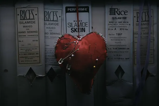 A heart-shaped pincushion bristling with needles hangs on the wall inside Kil Bae's store on Friday, March 27, 2026, in New York. (AP Photo/Andres Kudacki)