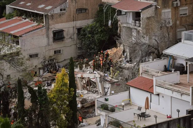  Israeli rescue teams search for missing people amid the rubble of a residential building a day after it was struck by an Iranian missile in Haifa, Israel, Monday, April 6, 2026. (AP) 