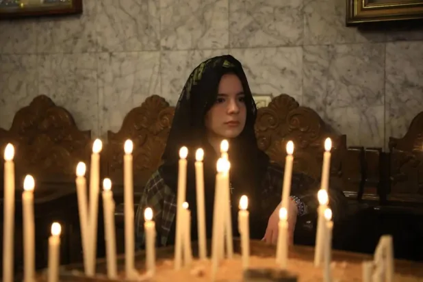  A Palestinian Christian woman attends a service at Saint Porphyrius Church in Gaza on Sunday (dpa). 