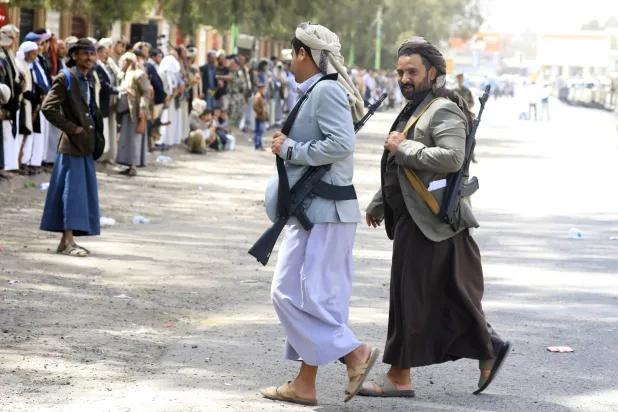 مسلحان حوثيان خلال تجمع في صنعاء للتضامن مع إيران (إ.ب.أ)