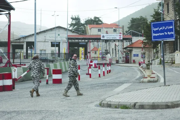 Lebanese General Security members stand guard at the Masnaa border crossing with Syria in the Bekaa Valley, eastern Lebanon, 05 April 2026, following an Israeli warning to target the M30 highway between Lebanon and Syria. (EPA)