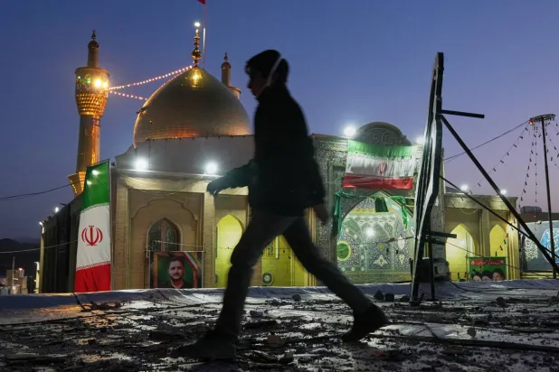 A youngster walks past a religious complex that Iranian officials say was hit by an airstrike in Zanjan, Iran, Saturday, April 4, 2026. (AP Photo/Francisco Seco)