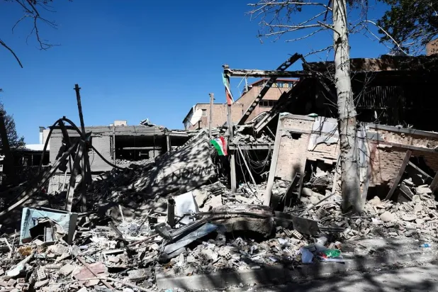 An Iranian flag lies amidst the rubble of a building of the Sharif University of Technology, which was damaged in a strike, amid the US-Israeli conflict with Iran, in Tehran, Iran, April 7, 2026. Majid Asgaripour/WANA (West Asia News Agency) via Reuters