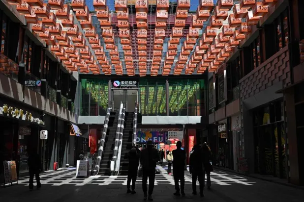 People visit a shopping center in Beijing on April 7, 2026. (AFP)