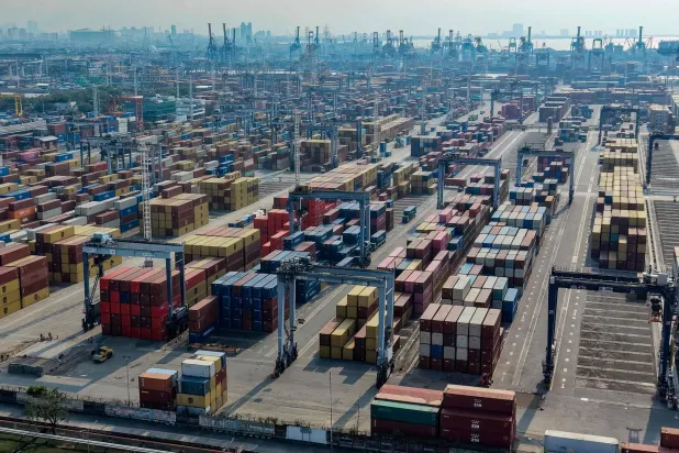 This aerial picture shows stacks of shipping containers at Tanjung Priok Port, Jakarta, March 31, 2026. (Photo by BAY ISMOYO / AFP)