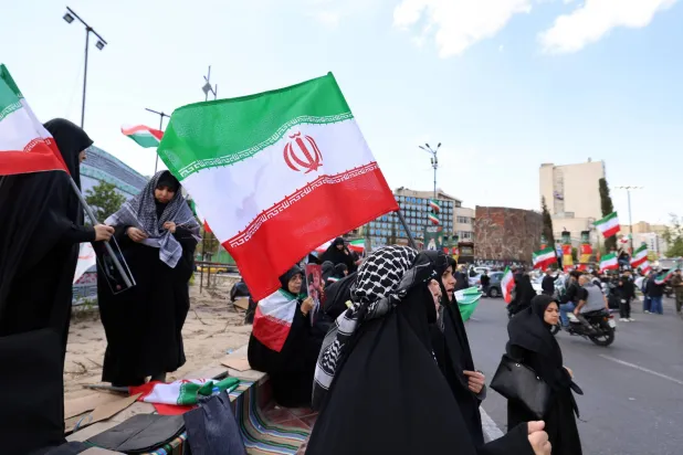 People wave Iranian national flags as they gather at Enghelab Square following the US-Iran ceasefire announcement, in Tehran, Iran, 08 April 2026. EPA/ABEDIN TAHERKENAREH