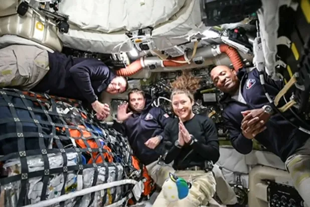 TOPSHOT - This screen grab from NASA's feed released on April 3, 2026, shows the four Artemis II crew members (L-R) Canadian Space Agency (CSA) astronaut Jeremy Hansen, Artemis II mission specialist, NASA astronauts Reid Wiseman, Artemis II commander, Christina Koch, Artemis II mission specialist and Victor Glover, Artemis II pilot as they head to orbit the Moon for the first time in more than half a century. The spacecraft lifted off from Kennedy Space Center in Florida at 18:35 EDT the previous day. (Photo by Handout / NASA TV / AFP)  