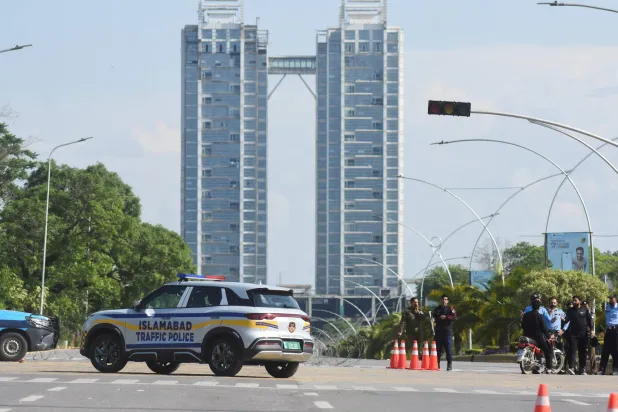 حراس أمن يقفون عند نقطة تفتيش ضمن تأهب أمني يسبق المحادثات الإيرانية-الأميركية في إسلام أباد (رويترز)